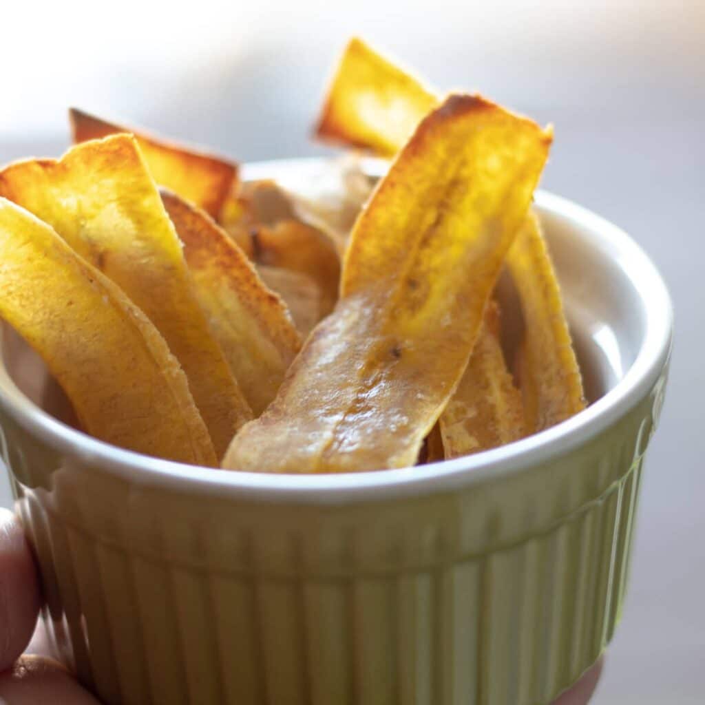 plantain chips in a green bowl