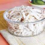 glass bowl with shredded chicken